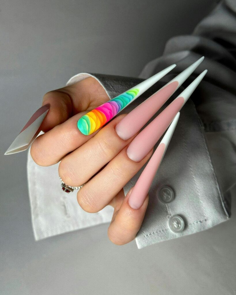 Close-up of colorful stiletto nails with rainbow accents, perfect for fashion inspiration.